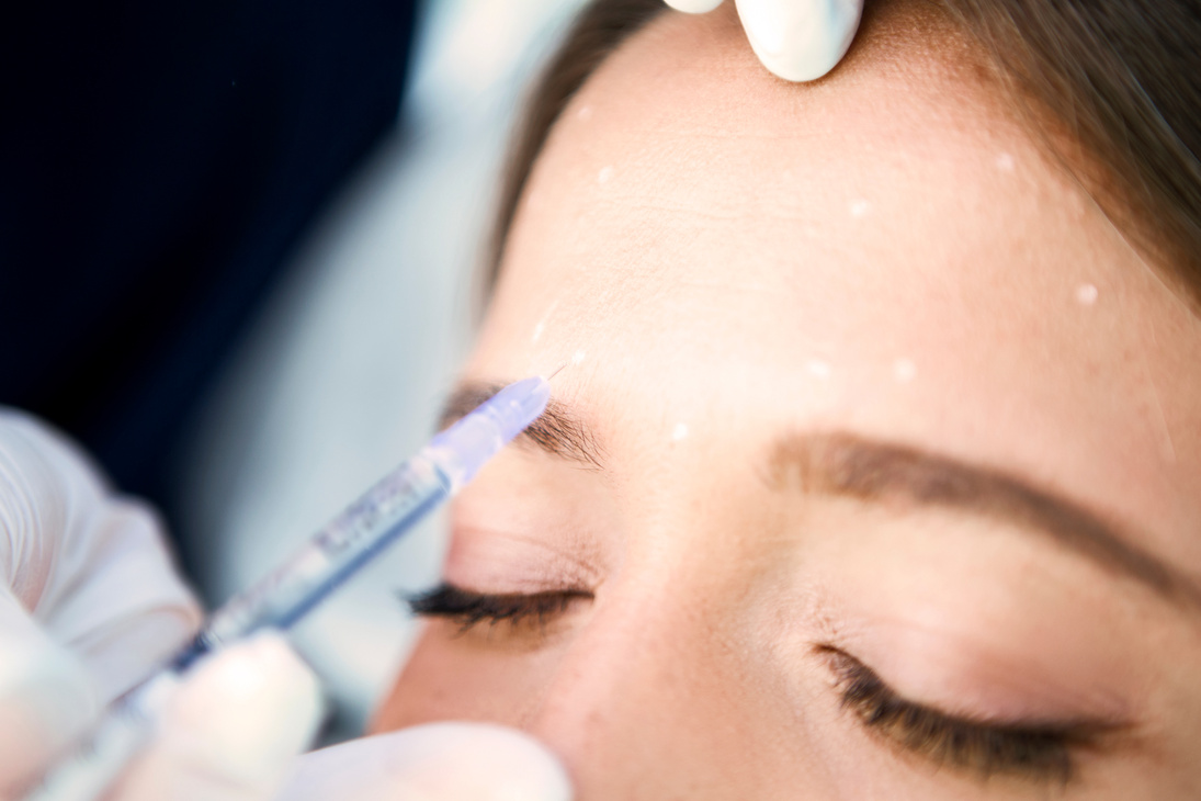 Young woman receiving botox injection